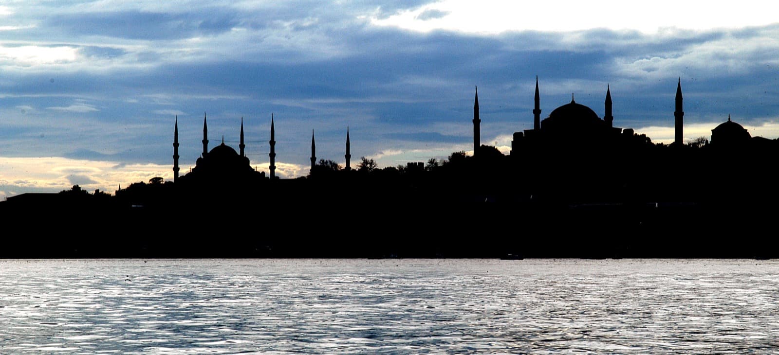 Silhouette of the Istanbul Old City skyline with mosque domes and minarets at sunset